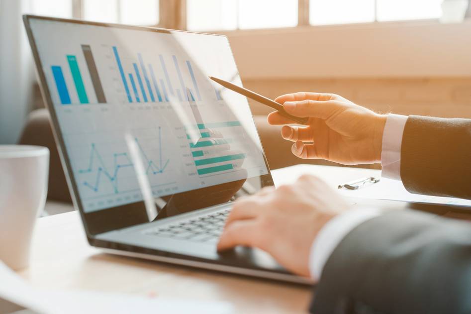 Calm desk setup with financial charts and dividend reports
